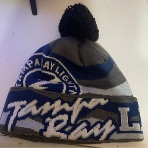 the beanie is made with mainly grey with blue and white writing